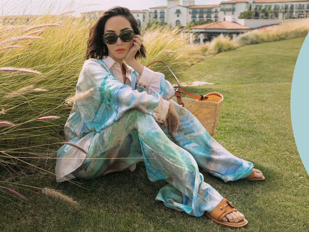 Ragazza con borsa in raffia su spiaggia tropicale